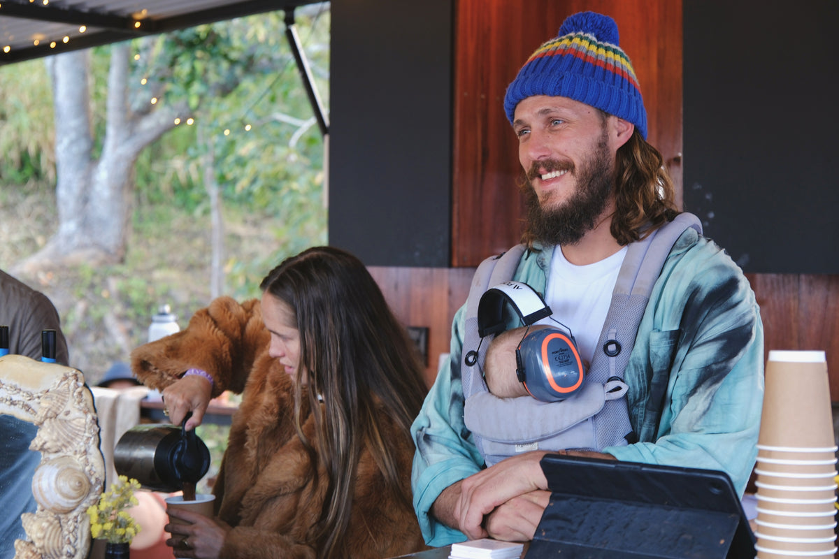Brad at the Against The Grain stall with his baby in a carrier